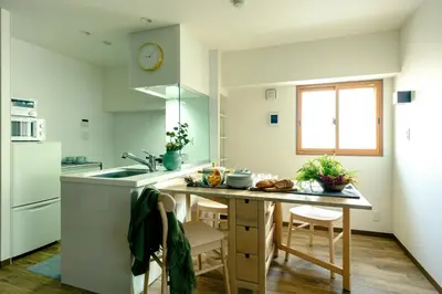 a kitchen with a table and a counter top at Home n Lounge in Tokyo