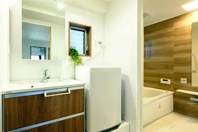 a bathroom with a sink and a refrigerator at Home n Lounge in Tokyo
