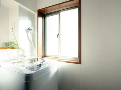 a white bathroom with a tub and a window at City Hideout in Tokyo