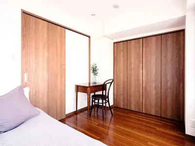 a bedroom with a bed and a desk and a table at City Hideout in Tokyo