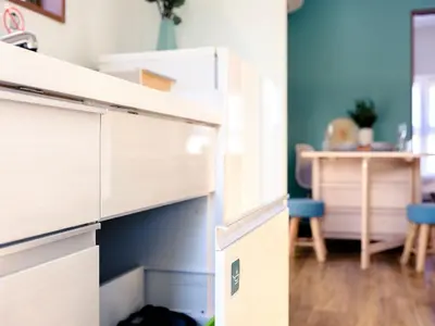 an open drawer in a kitchen with a table at City Hideout in Tokyo