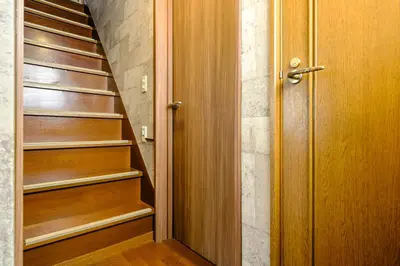 an empty closet with wooden shelves and a door at Ikken House in Tokyo