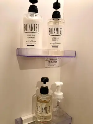 three bottles of soap on a shelf in a bathroom at bnb+ Shinbashi in Tokyo