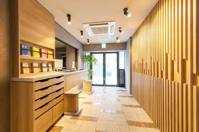 a hallway with a kitchen with wooden walls at HOTEL MYSTAYS Nippori in Tokyo