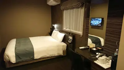 a hotel room with a bed and a television at Act Hotel Roppongi in Tokyo