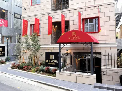 a restaurant with a red awning in front of a building at Act Hotel Roppongi in Tokyo