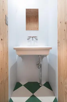 a bathroom with a sink and a green floor at Vacation
