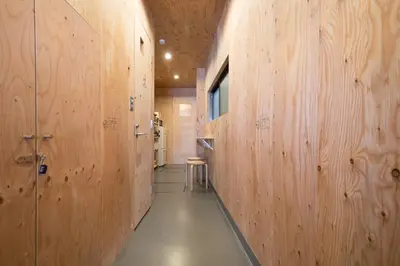 a hallway with wooden walls and a hallway with a walkway at Vacation
