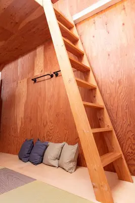 a room with a wooden wall with a ladder at Vacation