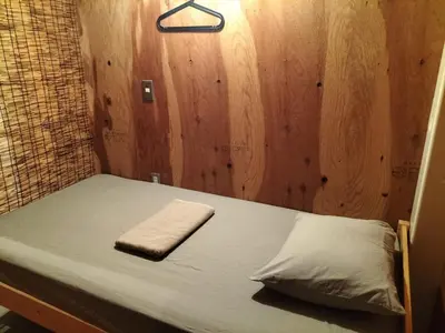 a bed in a small room with a towel on it at Vacation
