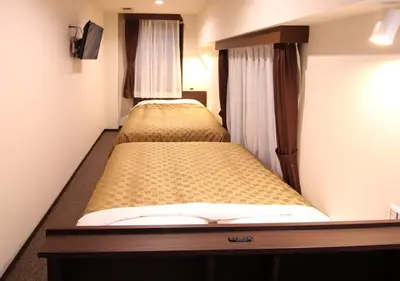 two beds in a small room with at Hotel Trend Asakusa Annex in Tokyo