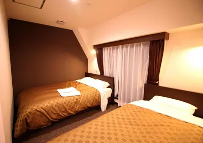 a hotel room with two beds and a window at Hotel Trend Asakusa Annex in Tokyo