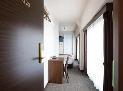 a bedroom with a bed and a desk in a room at Hotel Trend Asakusa Annex in Tokyo