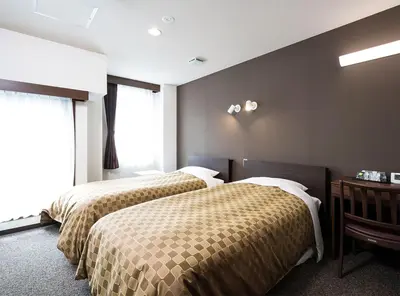 a hotel room with two beds and a window at Hotel Trend Asakusa Annex in Tokyo