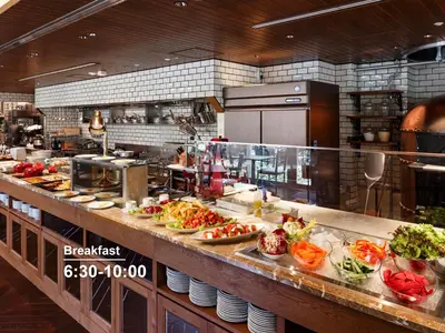 a kitchen with a buffet line with dishes of food at Mitsui Garden Hotel Gotanda - Tokyo in Tokyo