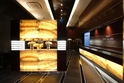 a lobby of a hotel with a large wall at HOTEL THE GLANZ in Tokyo