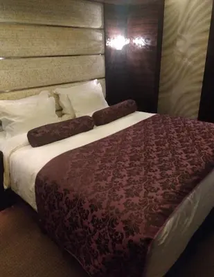 a bedroom with a large bed with a brown headboard at HOTEL THE GLANZ in Tokyo