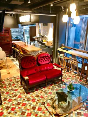 a living room with a red couch and a table at Andon Ryokan in Tokyo