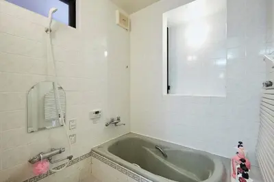 a bathroom with a bath tub and a mirror at F1-Upmarket Huose in Shinjuku in Tokyo
