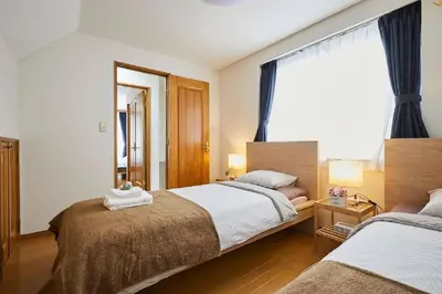 a hotel room with two beds and a window at F1-Upmarket Huose in Shinjuku in Tokyo