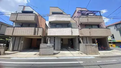 a building with balconies on the side of a street at F1-Upmarket Huose in Shinjuku in Tokyo