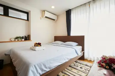 a bedroom with a bed and a large window at F1-Upmarket Huose in Shinjuku in Tokyo