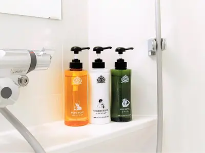 a bathroom with two shampoo bottles on a shelf at APA Hotel Nihombashi Bakurocho Ekikita in Tokyo