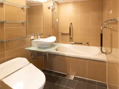 a bathroom with a toilet and a sink and a tub at APA Hotel Nihombashi Bakurocho Ekikita in Tokyo