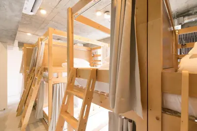 a group of bunk beds in a room at hostel DEN in Tokyo