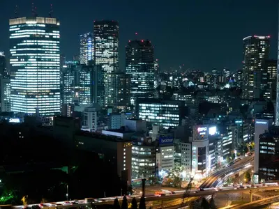 a city lit up at night with traffic at Toshi Center Hotel in Tokyo