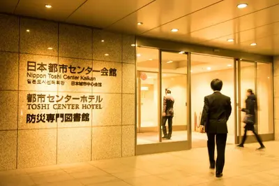 a man walking in front of a store at Toshi Center Hotel in Tokyo
