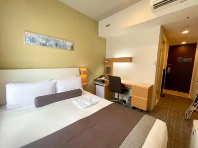 a bedroom with a bed and a desk with a computer at Tokyu Stay Kamata - Tokyo Haneda in Tokyo