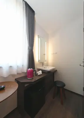 a bathroom with a sink and a counter with a mirror at Hotel Emit Ueno in Tokyo