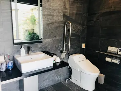 a bathroom with a white toilet and a sink at Hotel Emit Ueno in Tokyo