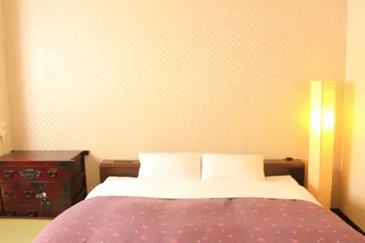 a bedroom with a bed and a wall with polka dots at K's House Tokyo Oasis - Quality Hostel in Asakusa in Tokyo