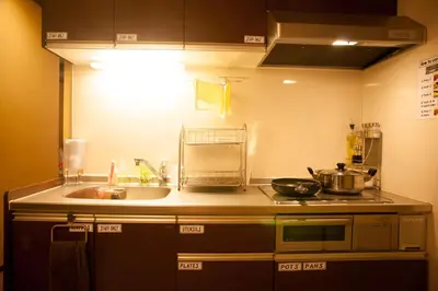 a kitchen with a sink and a stove top oven at K's House Tokyo Oasis - Quality Hostel in Asakusa in Tokyo