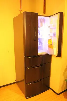 a large refrigerator with its door open in a kitchen at K's House Tokyo Oasis - Quality Hostel in Asakusa in Tokyo