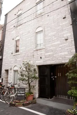 a brick building with a bike parked in front of it at K's House Tokyo Oasis - Quality Hostel in Asakusa in Tokyo