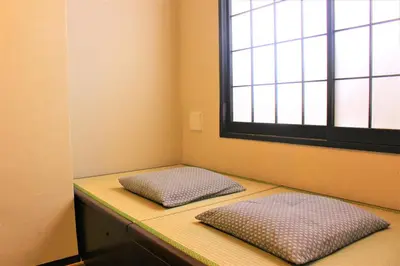 two pillows sitting on a counter in a room with a window at K's House Tokyo Oasis - Quality Hostel in Asakusa in Tokyo