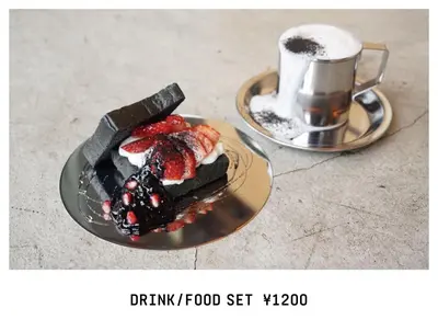 a plate with a piece of cake and a cup of coffee at Book And Bed Tokyo Shinjuku in Tokyo
