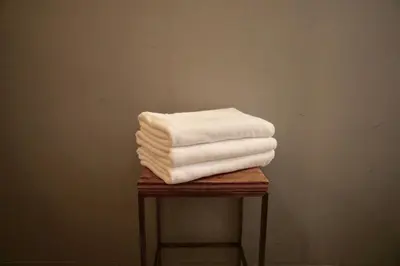 a pile of towels sitting on top of a table at Book And Bed Tokyo Shinjuku in Tokyo