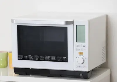 a white microwave oven sitting on top of a shelf at Urayasu Sun Hotel in Urayasu