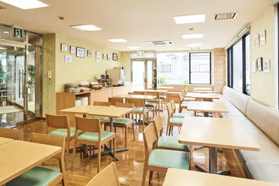an empty restaurant with tables and chairs at Urayasu Sun Hotel in Urayasu