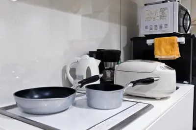 a kitchen counter with two frying pans and a toaster at House In Azabu in Tokyo