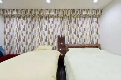 two beds sitting next to each other in a bedroom at House In Azabu in Tokyo