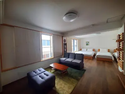 a living room with a bed and a couch at Rooms in Tokyo