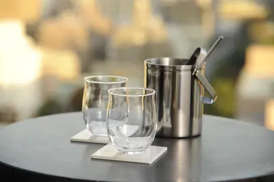 two empty glasses and a thermos on a table at Hotel Keihan Tsukiji Ginza Grande in Tokyo