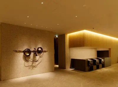 a lobby with a light fixture on the wall at Hotel Keihan Tsukiji Ginza Grande in Tokyo