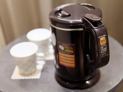 a coffee maker sitting on a table with a cup at Hotel Keihan Tsukiji Ginza Grande in Tokyo