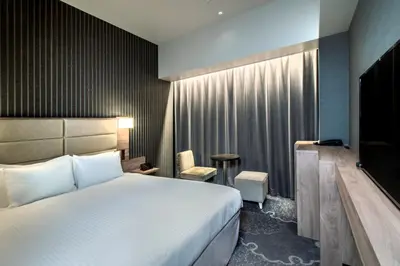 a hotel room with a bed and a television at Hotel Keihan Tsukiji Ginza Grande in Tokyo
